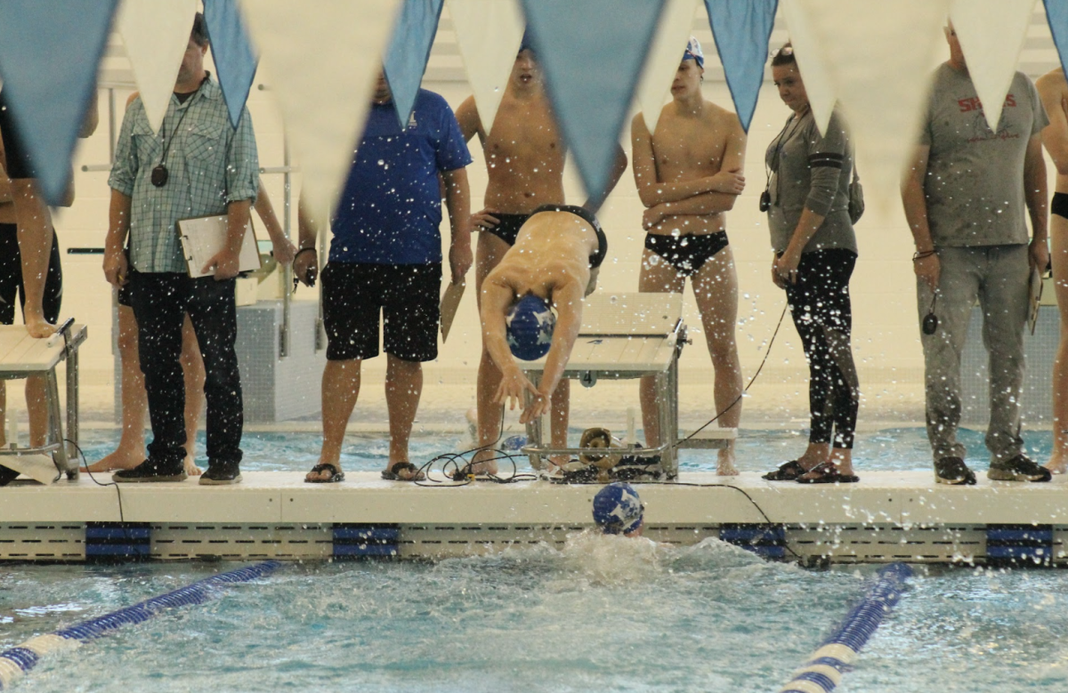 Ryan Schuber (10) dives in to the water. 